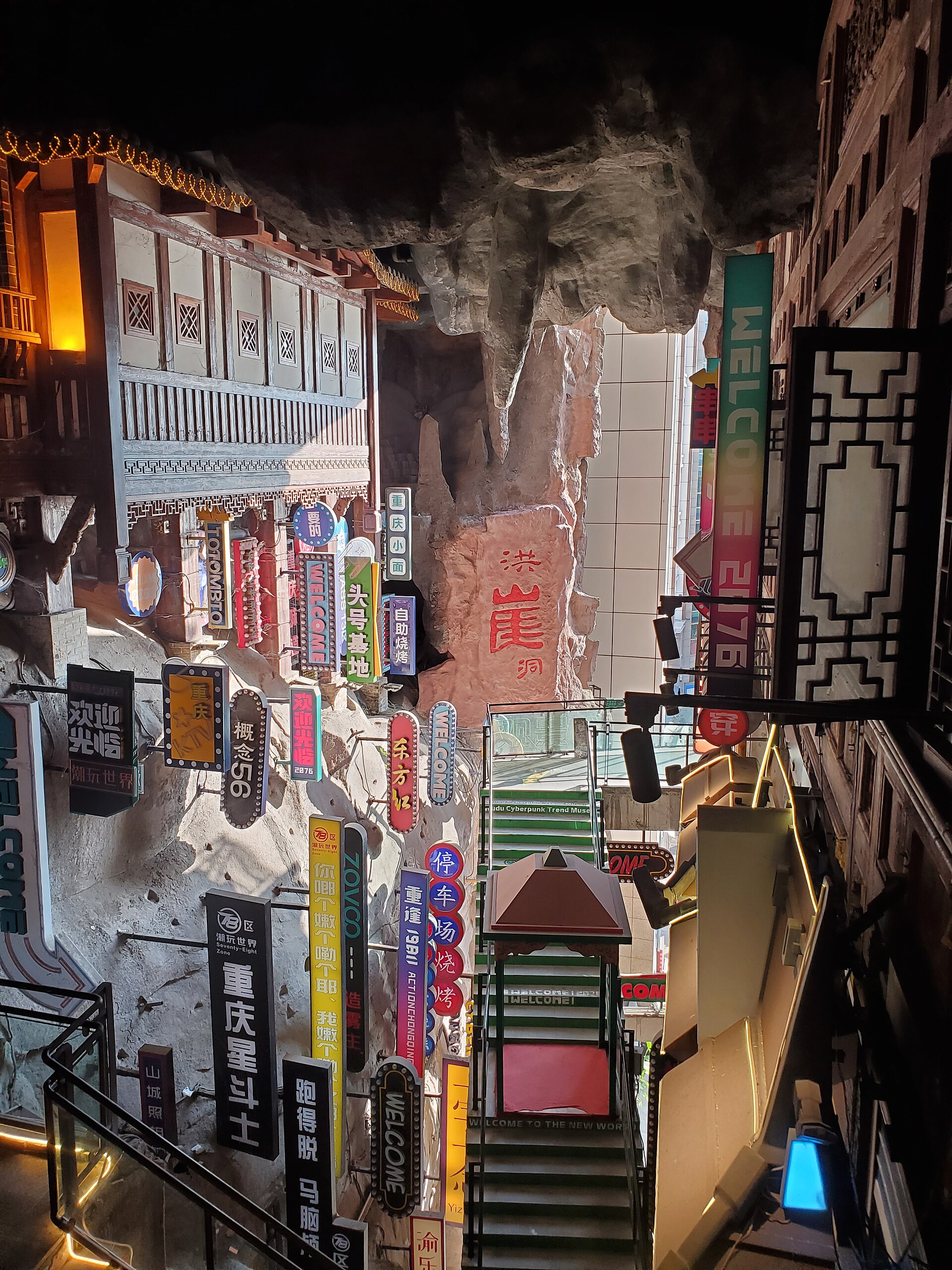 Hongya Cave's stilt houses lit gold over the river at night, Chongqing