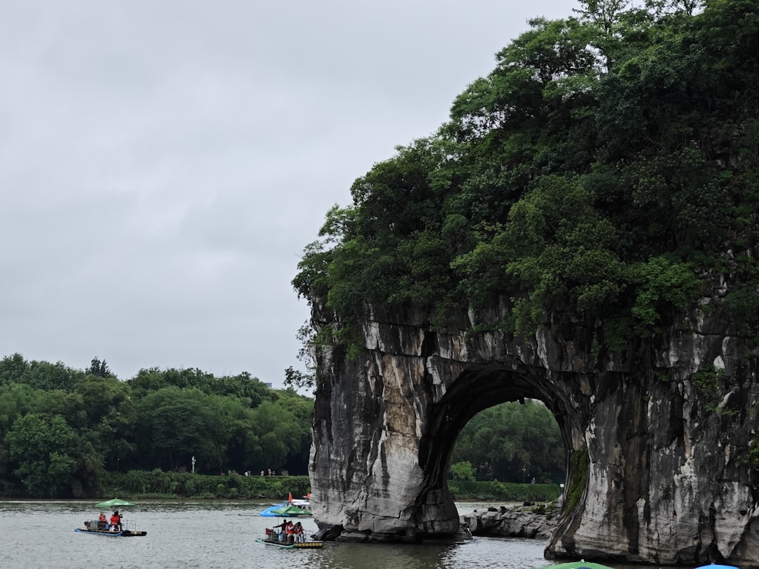 Elephant Trunk Hill at dusk — the elephant-shaped rock formation reflected in the Li River