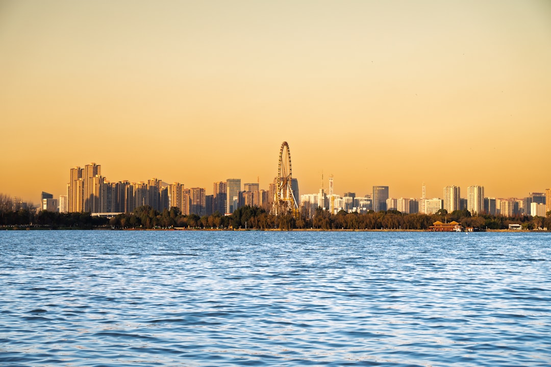Kunming skyline with Dianchi Lake and Western Hills in the background under clear blue skies