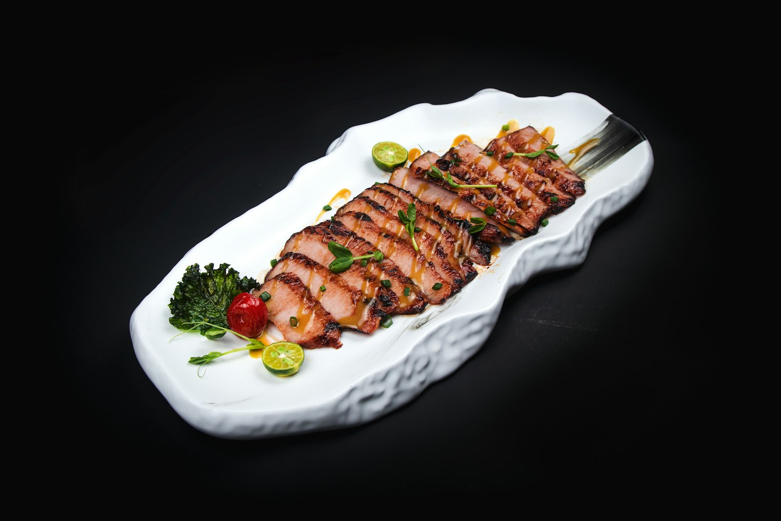 Nanjing salted duck — pale golden skin, sliced thin on a white plate, glistening with brine