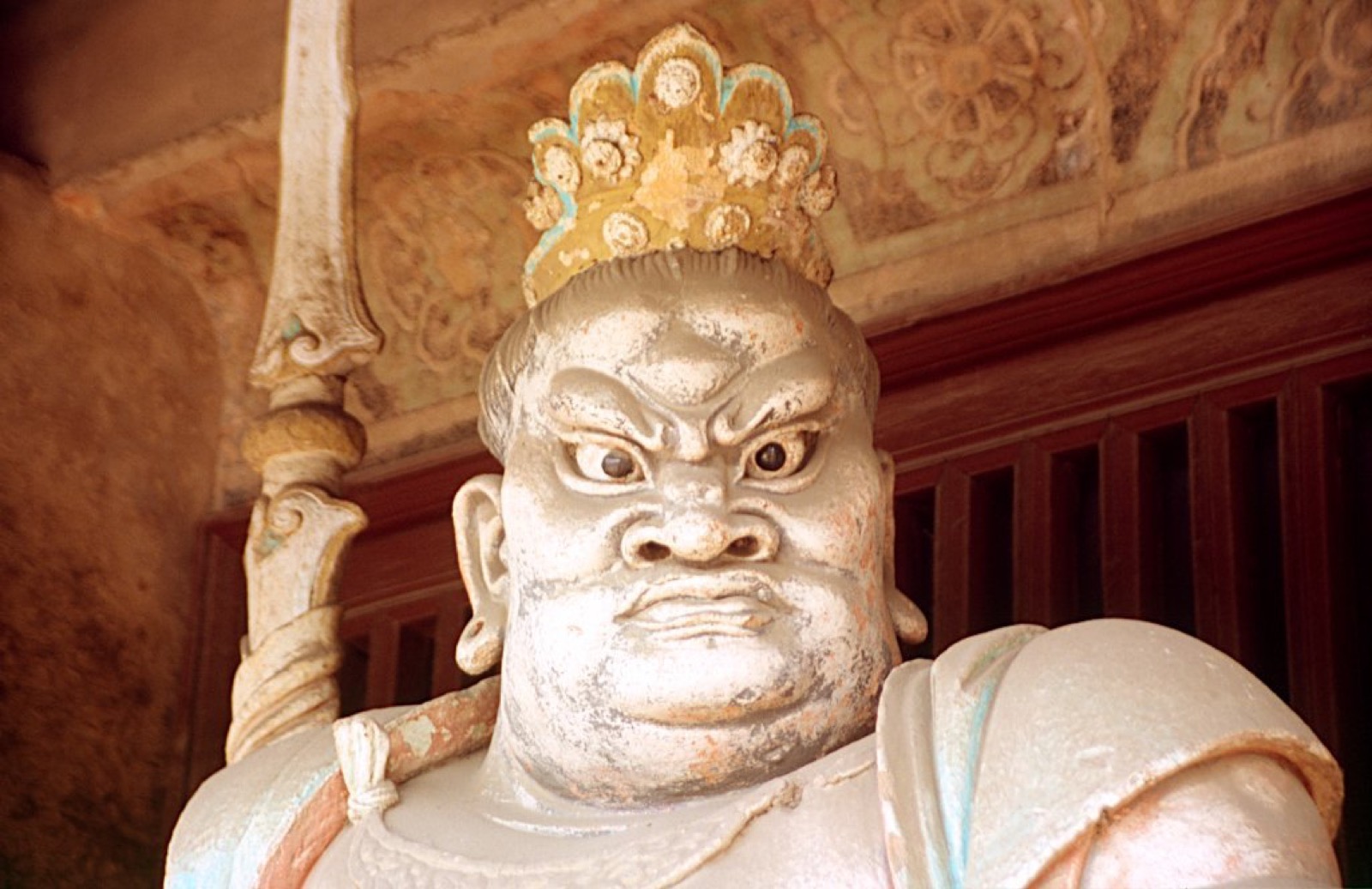 Ming-dynasty painted clay Bodhisattva sculptures inside a dim hall at Shuanglin Temple near Pingyao