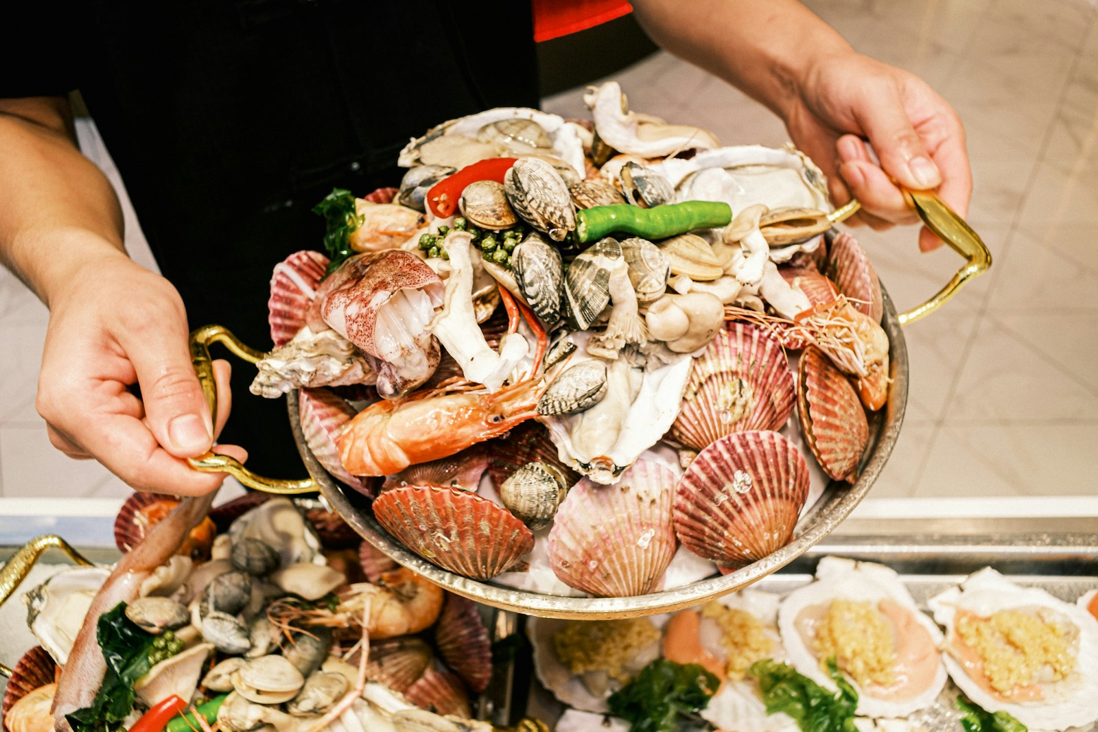 Qingdao seafood spread — spicy stir-fried clams, grilled squid and a plastic bag of fresh draft Tsingtao