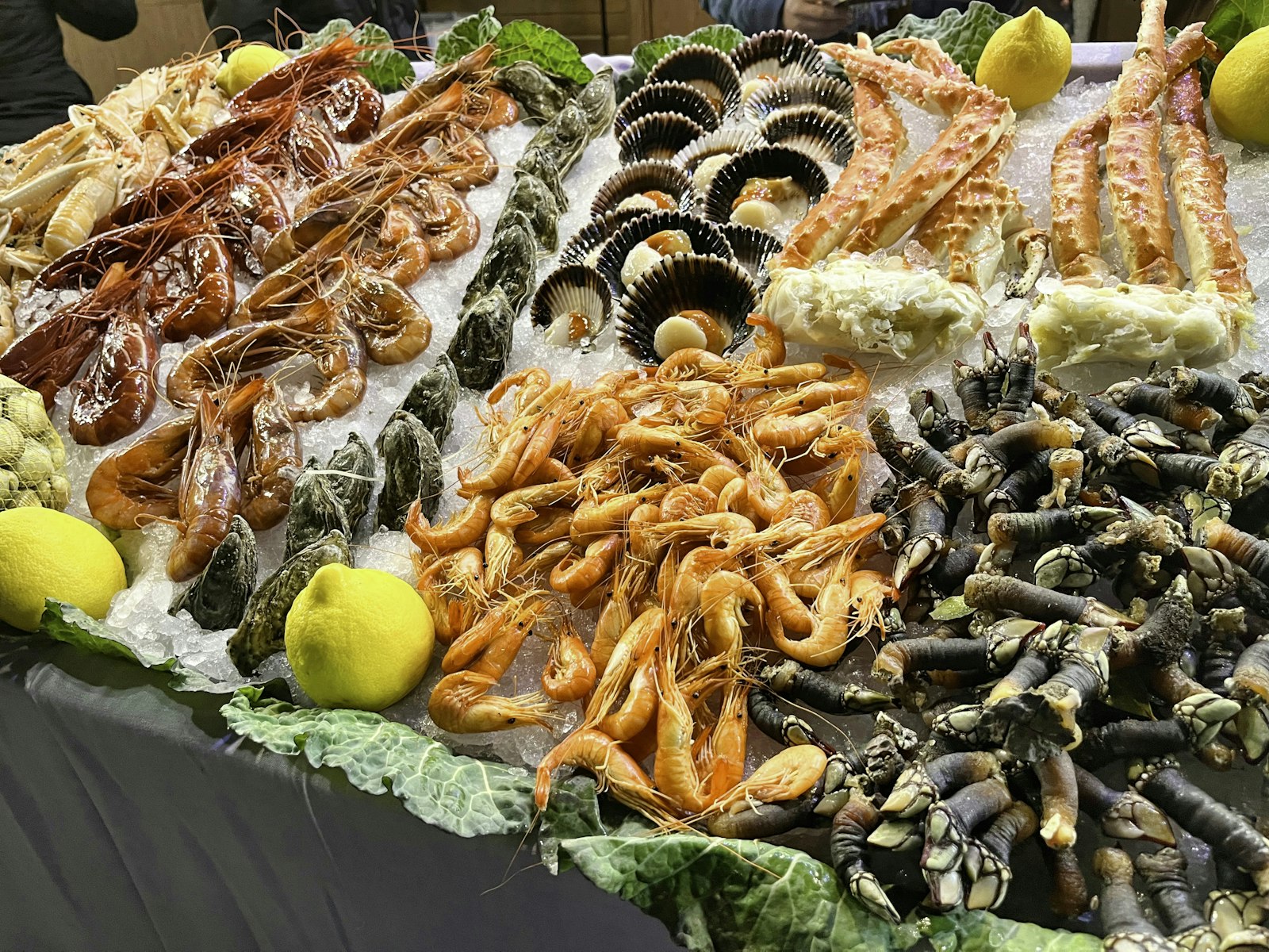 A spread of fresh Sanya seafood — garlic-steamed lobster, salt-and-pepper mantis shrimp, steamed crab — at a First Market processing restaurant