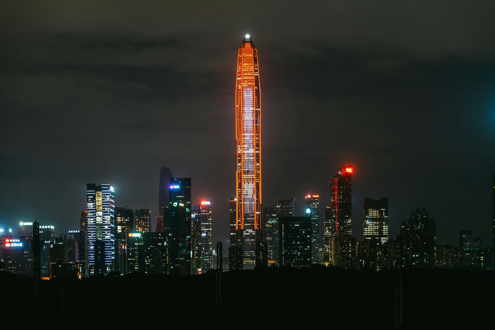 Shenzhen's Futian skyline at dusk, the Ping An tower spearing the clouds above the CBD