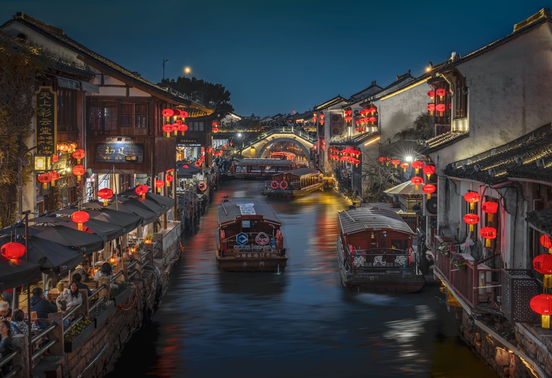 Shantang Street at night — red lanterns, canal reflections, illuminated old houses